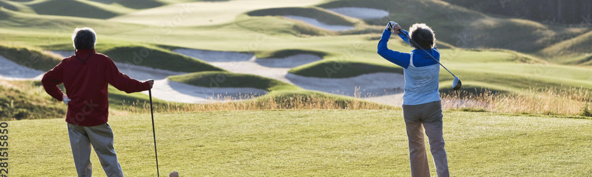 Two golfers enjoying a sunny day outside