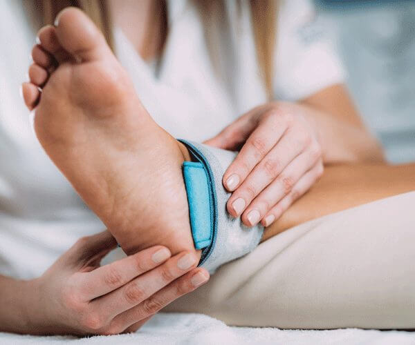 A doctor examining a patient's ankle