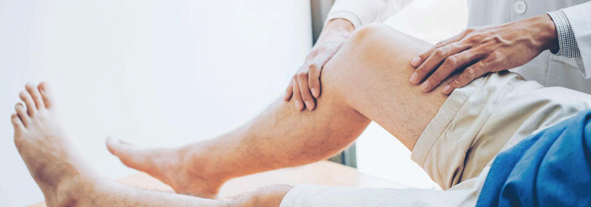 A doctor testing the range of motion in a patient's leg A doctor testing the range of motion in a patient's leg